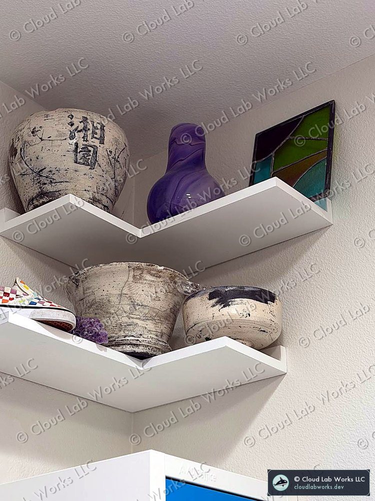 Corner shelf with raku-fired pots: white crackle glaze, copper and black flashing, one with two brushed Japanese characters